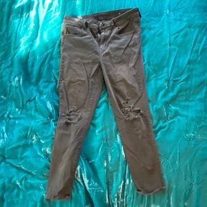 Black AE jeans with ripped knee holes